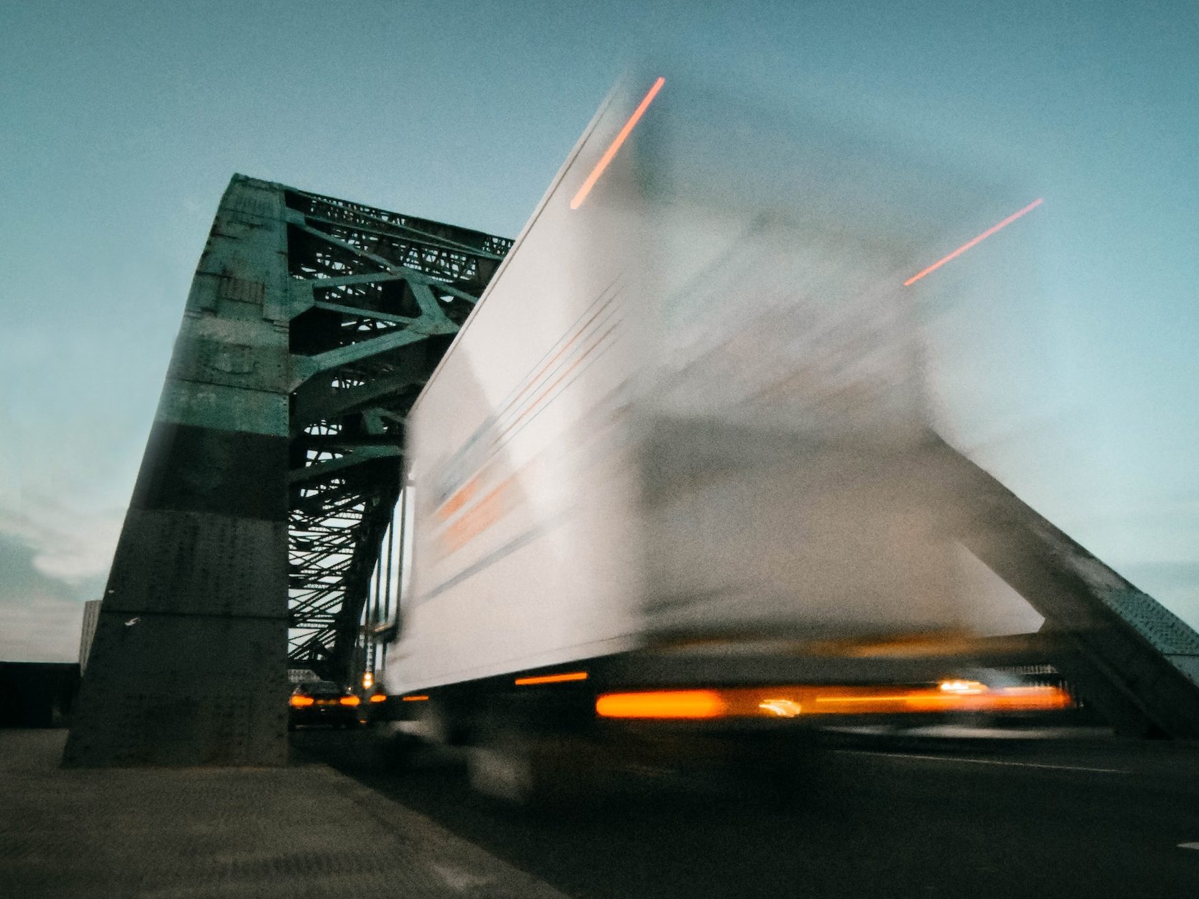 time lapse photography of truck going on bridge